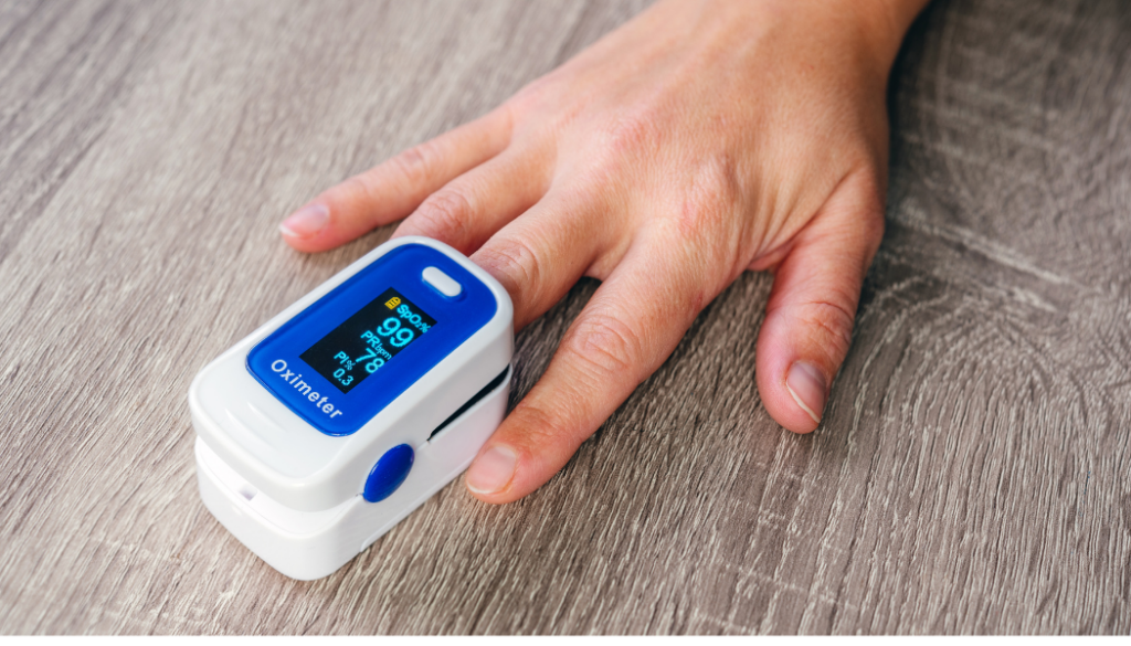 Finger pulse oximeter with oxygen and pulse readings.