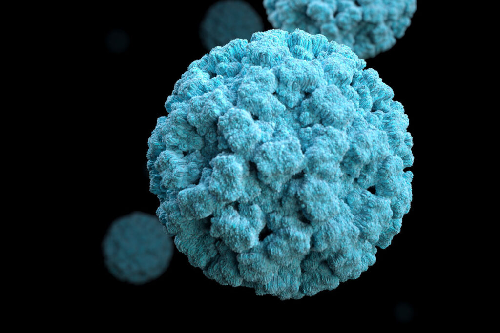 Blue textured spherical particle with smaller blurred particles behind it.
