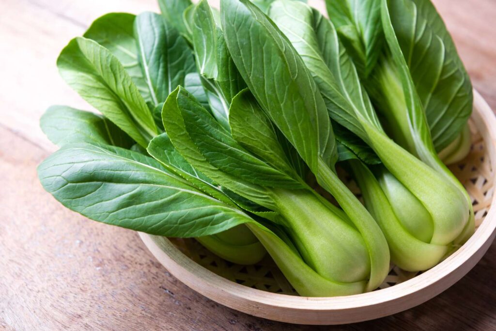 Leafy green vegetables in a basket.