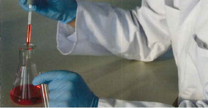 Gloved hands performing a laboratory procedure.